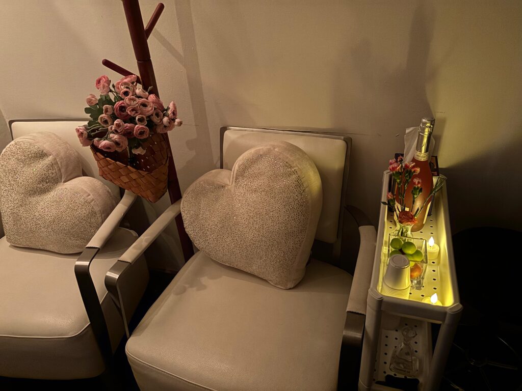 Candlelit couples massage suite at Little Break Spa with warm towels and romantic ambiance.